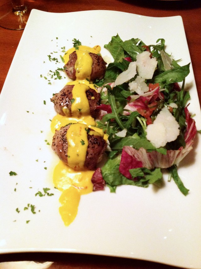 Baked Canadian sea scallops wrapped in Muscovy duck breast served on chicory