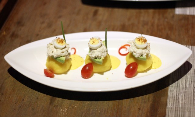 Mashed potatoes topped wth crab meat in a togarashi mayo with avocade, quail egg and and huacaina sauce Above 11, Bangkok