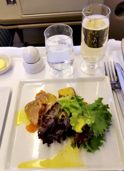 Singapore Airlines Business Class meal with champagne
